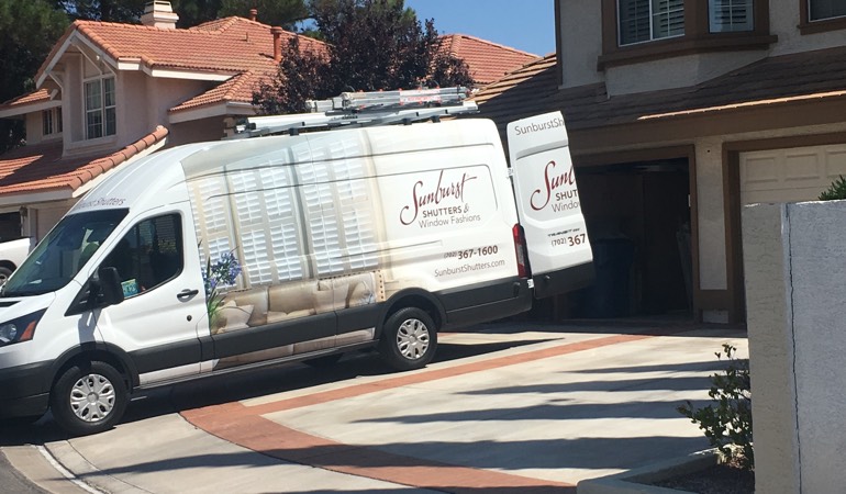 Alt text: Sunburst Shutters van at customer's home.